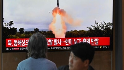 People watch a television screen showing a news broadcast with file footage of a North Korean missile test, at a railway station in Seoul. (AFP)