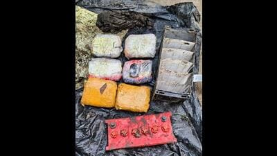 The packets of narcotics and the battery in which they were concealed near the border fence at Dostpur village in Gurdaspur district. (HT Photo)