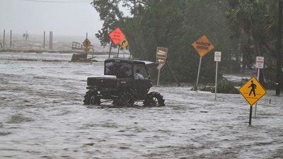People ride though the flooded street near the Steinhatchee marina after hurricane Idalia hit in Steinhatchee, Florida, on August 30, 2023. Idalia barreled into the northwest Florida coast as a powerful Category 3 hurricane on Wednesday morning, the US National Hurricane Center said. "Extremely dangerous Category 3 Hurricane #Idalia makes landfall in the Florida Big Bend," it posted on X, formerly known as Twitter, adding that Idalia was causing "catastrophic storm surge and damaging winds." (AFP) People ride though the flooded street near the Steinhatchee marina after hurricane Idalia hit in Steinhatchee, Florida, on August 30, 2023. Idalia barreled into the northwest Florida coast as a powerful Category 3 hurricane on Wednesday morning, the US National Hurricane Center said. "Extremely dangerous Category 3 Hurricane #Idalia makes landfall in the Florida Big Bend," it posted on X, formerly known as Twitter, adding that Idalia was causing "catastrophic storm surge and damaging winds." (AFP)