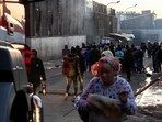 People walk past a building after a deadly blaze in the early hours of the morning, in Johannesburg, South Africa August 31.
