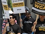 Hollywood writers and their supporters from the SAG AFTRA actors' union walk the picket line outside Warner Bros Studios in Burbank, California. (Photo by Robyn Beck / AFP) Hollywood writers and their supporters from the SAG AFTRA actors' union walk the picket line outside Warner Bros Studios in Burbank, California. (Photo by Robyn Beck / AFP)