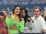 Priyanka Chopra and Danielle Jonas at concert.