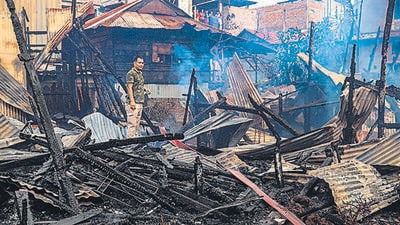 A man stands amid the charred remains of houses burned down, during the ongoing ethnic violence, in Imphal on August 27. (AFP) A man stands amid the charred remains of houses burned down, during the ongoing ethnic violence, in Imphal on August 27. (AFP)