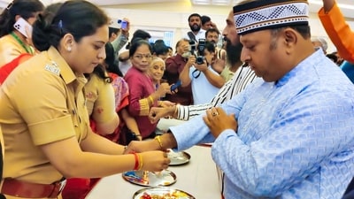 A woman police personnel ties rakhi on the wrist of a man on the occasion of Raksha Bandhan during Hindu Muslim Raksha Bandhan event organised by Thane Town police station and NGO Shiv Mudra Prabhodini at Mahajan wadi hall in Thane. (ANI) A woman police personnel ties rakhi on the wrist of a man on the occasion of Raksha Bandhan during Hindu Muslim Raksha Bandhan event organised by Thane Town police station and NGO Shiv Mudra Prabhodini at Mahajan wadi hall in Thane. (ANI)