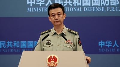 Chinese defence ministry spokesperson Wu Qian attends a press briefing in Beijing, China. (Reuters)