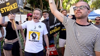 Bryan Cranston and Aaron Paul, cast members from Breaking Bad, strike on a picket line outside Sony Pictures studios on Aug. 29. (AP)