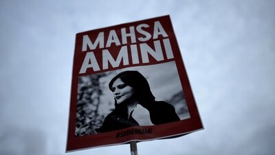 Iran Anti-Hijab Protests: A woman holds a placard with a picture of Iranian woman Mahsa Amini during a protest against her death. (AP) Iran Anti-Hijab Protests: A woman holds a placard with a picture of Iranian woman Mahsa Amini during a protest against her death. (AP)