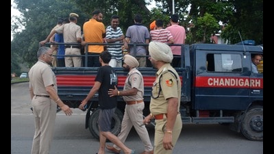 Police detaining youths after a surprise check at PU hostels on Thursday morning. They were later let off after police confirmed that they were all PU students. (Sant Arora/HT) Police detaining youths after a surprise check at PU hostels on Thursday morning. They were later let off after police confirmed that they were all PU students. (Sant Arora/HT)