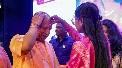 Uttar Pradesh chief minister Yogi Adityanath celebrates Raksha Bandhan with beneficiaries of the Kanya Sumangala Yojana in Lucknow. (PTI) Uttar Pradesh chief minister Yogi Adityanath celebrates Raksha Bandhan with beneficiaries of the Kanya Sumangala Yojana in Lucknow. (PTI)