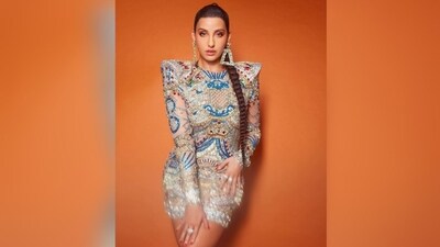 Assisted by celebrity fashion stylist Shaleena Nathani, Nora accessorised her look with dazzling silver accessories, including an oversized silver statement triangle earring and quirky silver rings adorning her fingers. (Instagram/@norafatehi) Assisted by celebrity fashion stylist Shaleena Nathani, Nora accessorised her look with dazzling silver accessories, including an oversized silver statement triangle earring and quirky silver rings adorning her fingers. (Instagram/@norafatehi)