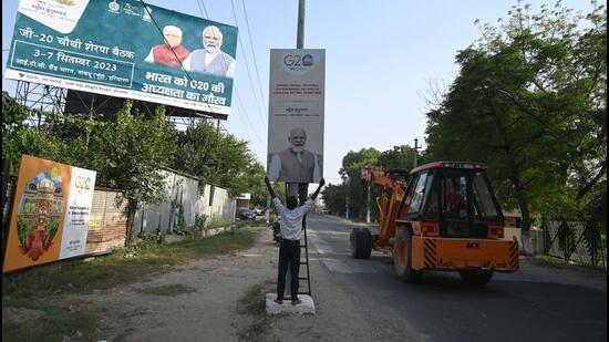 A hoarding for the G20 Sherpa meeting is installed on the Naurangpur-Tauru Road near National Highway 48 in Gurugram on Thursday. (Parveen Kumar/HT Photo)