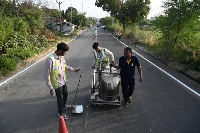 Road repair work on the Naurangpur-Tauru Road near Bar-Gujjar village in Gurugram on Thursday. NHAI said work on improving the roads from the Delhi border to the venue has been completed. (Parveen Kumar/HT Photo) Road repair work on the Naurangpur-Tauru Road near Bar-Gujjar village in Gurugram on Thursday. NHAI said work on improving the roads from the Delhi border to the venue has been completed. (Parveen Kumar/HT Photo)