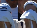 John Isner hiding his face with a towel