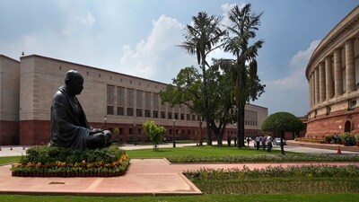A statue of Mahatma Gandhi sits between the old and new Parliament House buildings. (AP)