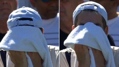 John Isner hiding his face with a towel John Isner hiding his face with a towel