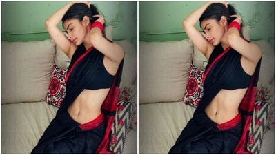 Mouni looked every bit gorgeous in a black and red cotton saree as she teamed it with a sleeveless black blouse.&nbsp; (Instagram/@imouniroy)