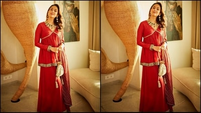 For her look, Mira chose a red suit featuring a V-neck flared top with full sleeves and gold embroidered borders. She teamed it with matching flared palazzo pants and a printed dupatta. (Instagram/@mira.kapoor)