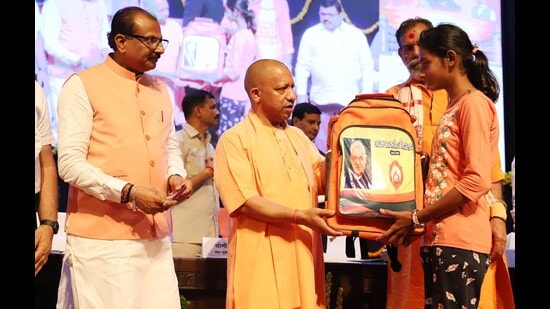 Uttar Pradesh chief minister Yogi Adityanath distributing bags to students of Atal Residential School in Lucknow on September 1. (Sourced)