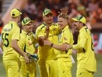 Australia's Nathan Ellis celebrates taking a wicket with teammates 