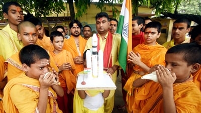Students and priests extend their wishes to the ISRO's Aditya-L1, ahead of its launch, in Patna, Saturday. (PTI) Students and priests extend their wishes to the ISRO's Aditya-L1, ahead of its launch, in Patna, Saturday. (PTI)