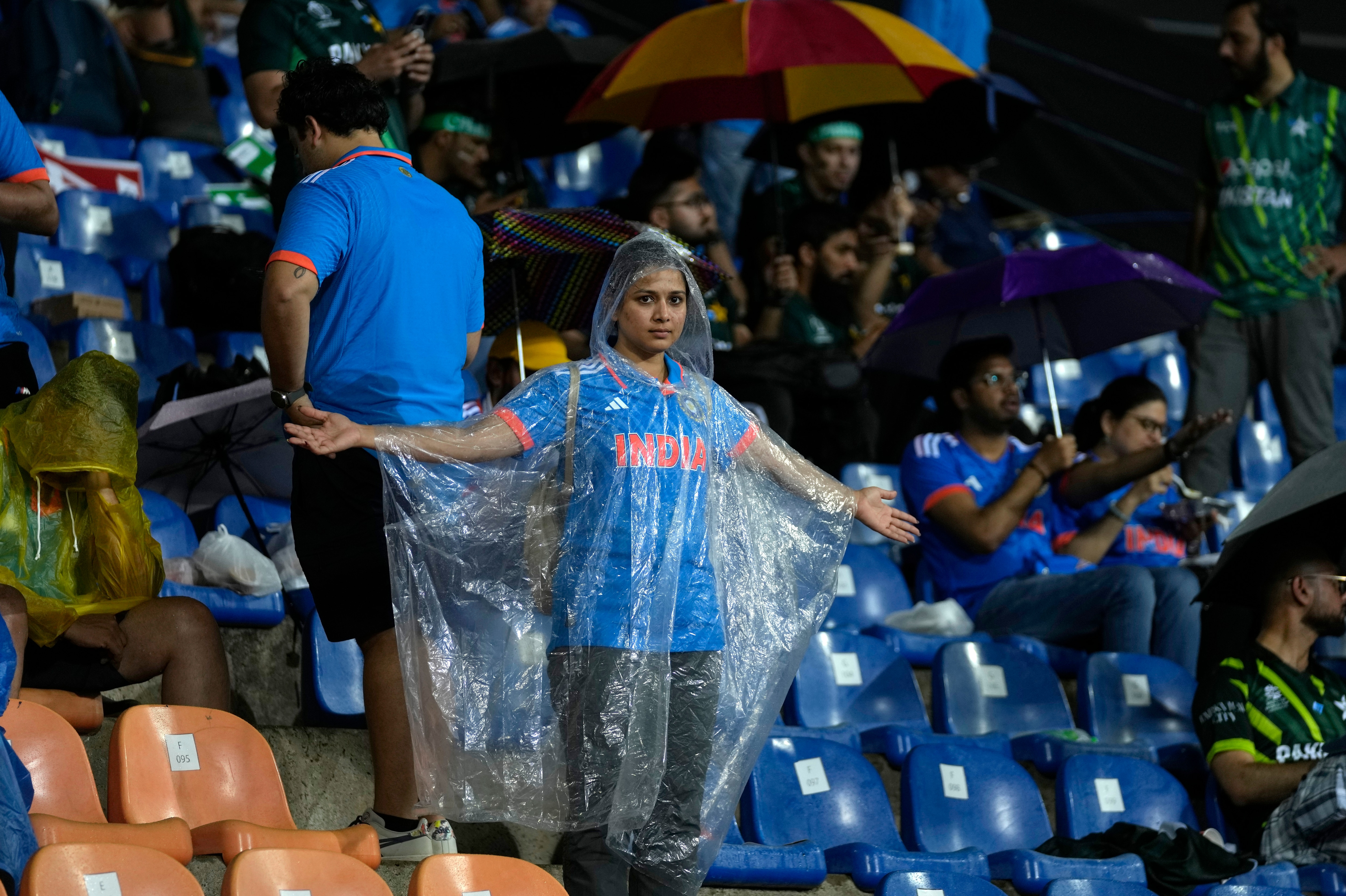 Spectators wait as the play interrupted by rain during the Asia Cup cricket match between India and Pakistan in Pallekele, Sri Lanka on Saturday, Sep. 2. (AP Photo/Eranga Jayawardena) (AP)