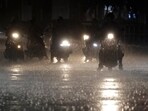 Riders wait at the intersection under heavy rain as the Typhoon Haikui approaches the country. Riders wait at the intersection under heavy rain as the Typhoon Haikui approaches the country.