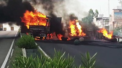 Flames and smoke billow out of the truck that overturned and caught fire after an accident with another vehicle, at Goraya in Jalandhar on Sunday. (ANI)