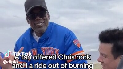Diplo and Chris Rock escape mud pit at Burning Man festival, hitchhike to safety. (X/TTEcclesBrown) Diplo and Chris Rock escape mud pit at Burning Man festival, hitchhike to safety. (X/TTEcclesBrown)