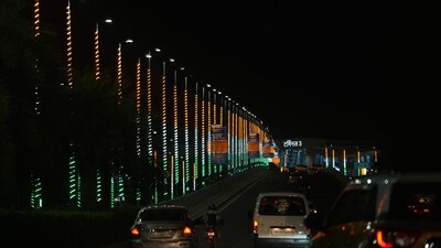 In this photo, vehicles move on a road decorated in tri-colours near Terminal 3 of Indira Gandhi Internation Airport in New Delhi, Saturday. As the world's largest democracy, India seeks to play a crucial role in the summit under its presidency. G20 has mainly two main tracks of engagement: the Finance Track and the Sherpa Track. The Sherpas act as personal envoys of the leaders of member nations, coordinating for the summit. (PTI)