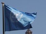 The flag of the United Nations flutters.