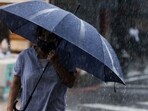 Typhoon Haikui: A woman walks with an umbrella during heavy rain near Su-ao port in Yilan as Typhoon Haikui makes landfall in eastern Taiwan. Typhoon Haikui: A woman walks with an umbrella during heavy rain near Su-ao port in Yilan as Typhoon Haikui makes landfall in eastern Taiwan.