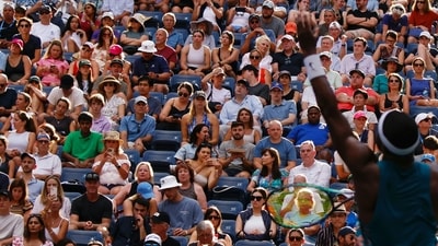 Attendees watch as USA's Frances Tiafoe serves to Australia's Rinky Hijikata during the US Open tennis tournament men's singles round of 16 match at the USTA Billie Jean King National Tennis Center (AFP)