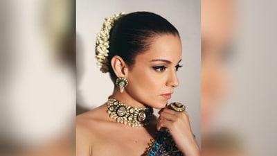 She wore shimmering eye shadow, black winged eyeliner, nude lipstick and her hair was tied up in a neat bun and adorned with white gajra. She completed her regal look with a green Kundun choker necklace, matching statement earrings and a ring on her fingers. (Instagram/@kanganaranaut) She wore shimmering eye shadow, black winged eyeliner, nude lipstick and her hair was tied up in a neat bun and adorned with white gajra. She completed her regal look with a green Kundun choker necklace, matching statement earrings and a ring on her fingers. (Instagram/@kanganaranaut)
