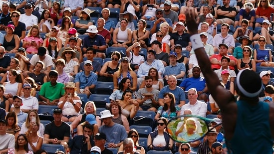 Attendees watch as USA's Frances Tiafoe serves to Australia's Rinky Hijikata during the US Open tennis tournament men's singles round of 16 match at the USTA Billie Jean King National Tennis Center (AFP)