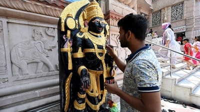 An artist gives final touches to the idol of Lord Shri Krishna ahead of Krishna Janmashtami at ISKCON temple, Sector 33, in Noida. (HT Photo/Sunil Ghosh)