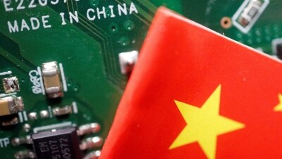 A Chinese flag is displayed next to a "Made in China" sign seen on a printed circuit board with semiconductor chips, in this illustration. (REUTERS)