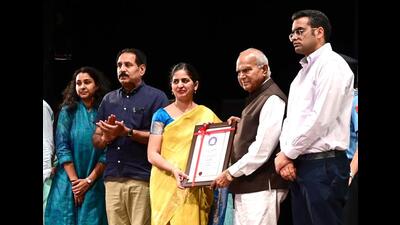 Chandigarh administrator Banwarilal Purohit presenting State Award to a teacher on the occasion of Teachers’ Day at Tagore Theatre in Chandigarh on Tuesday. (Keshav Singh/HT)