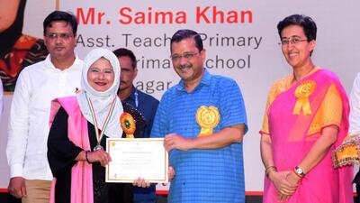 Delhi chief minister Arvind Kejriwal with education minister Atishi during Teacher’s Day celebrations at Thyagraj stadium. (HT Photo)