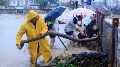 Residents remove debris from a flooded area in the town of Volos, central Greece, Tuesday. (AP) Residents remove debris from a flooded area in the town of Volos, central Greece, Tuesday. (AP)