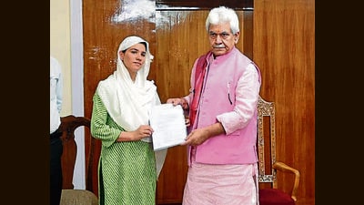 Lieutenant Governor Manoj Sinha handing over a job letter to a beneficiary on Tuesday. (HT Photo)