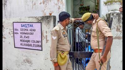 Police personnel stand guard outside a house as a raid is conducted by the National Investigation Agency (NIA), in Prayagraj, Tuesday. (PTI Photo) Police personnel stand guard outside a house as a raid is conducted by the National Investigation Agency (NIA), in Prayagraj, Tuesday. (PTI Photo)