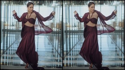 Her three-piece outfit comes in a maroon shade and features a halterneck bralet top, a draped skirt and an open organza jacket with full sleeves. (Instagram/@kareenakapoorkhan) Her three-piece outfit comes in a maroon shade and features a halterneck bralet top, a draped skirt and an open organza jacket with full sleeves. (Instagram/@kareenakapoorkhan)