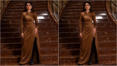 Her dress featured a short neckline, full sleeves, a fitted bodice, a maxi-length hem, a drape pattern at the waist and a thigh-high side slit that added an oomph factor to her look. (Instagram/@mrunalthakur) Her dress featured a short neckline, full sleeves, a fitted bodice, a maxi-length hem, a drape pattern at the waist and a thigh-high side slit that added an oomph factor to her look. (Instagram/@mrunalthakur)