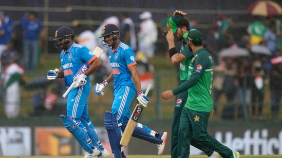 India's Rohit Sharma, left, and Shubman Gill run back to pavilion as it rains during the Asia Cup cricket match between India and Pakistan in Pallekele, (AP)