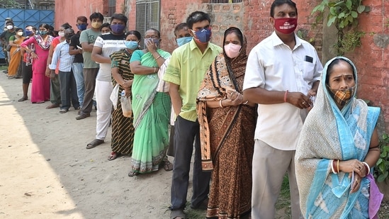 Voters stand in line during polling for the seventh phase of the West Bengal assembly elections in Kolkata. (Representational Image / PTI)
