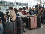 Passengers are seen waiting for delayed flights in London's Heathrow airport. (AP) Passengers are seen waiting for delayed flights in London's Heathrow airport. (AP)