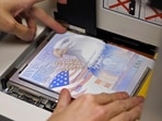 (FILES) A US government official with the State Department's Passport Services places a new blank US Passport with an embedded electronic chip into the "book printer," entering personal data and the photograph of an applicant on June 14, 2007, in Washington, DC. It is an "unprecedented demand", which comes up against the need to "rebuild" a service practically dismantled during covid, US Secretary od State Antony Blinken acknowledged, as travel surges post-Covid. The US State Department asked citizens to "check the expiration date of the document and renew it" as soon as possible before traveling. (FILES) A US government official with the State Department's Passport Services places a new blank US Passport with an embedded electronic chip into the "book printer," entering personal data and the photograph of an applicant on June 14, 2007, in Washington, DC. It is an "unprecedented demand", which comes up against the need to "rebuild" a service practically dismantled during covid, US Secretary od State Antony Blinken acknowledged, as travel surges post-Covid. The US State Department asked citizens to "check the expiration date of the document and renew it" as soon as possible before traveling.