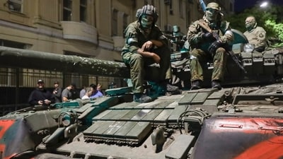 Members of the Wagner Group military company sit atop of a tank on a street in Rostov-on-Don, Russia. (AP) Members of the Wagner Group military company sit atop of a tank on a street in Rostov-on-Don, Russia. (AP)