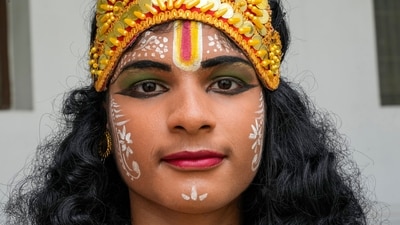 In the event, participants called ‘Govindas’, dressed in colourful clothes, made a human pyramid to reach the pot hung mid-air, and break it. (AP) In the event, participants called ‘Govindas’, dressed in colourful clothes, made a human pyramid to reach the pot hung mid-air, and break it. (AP)