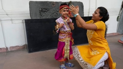 A mother gives final touches to her child dressed as Hindu deity Krishna prior to an event on the occasion of Janmashtami in Kolkata. (AP) A mother gives final touches to her child dressed as Hindu deity Krishna prior to an event on the occasion of Janmashtami in Kolkata. (AP)